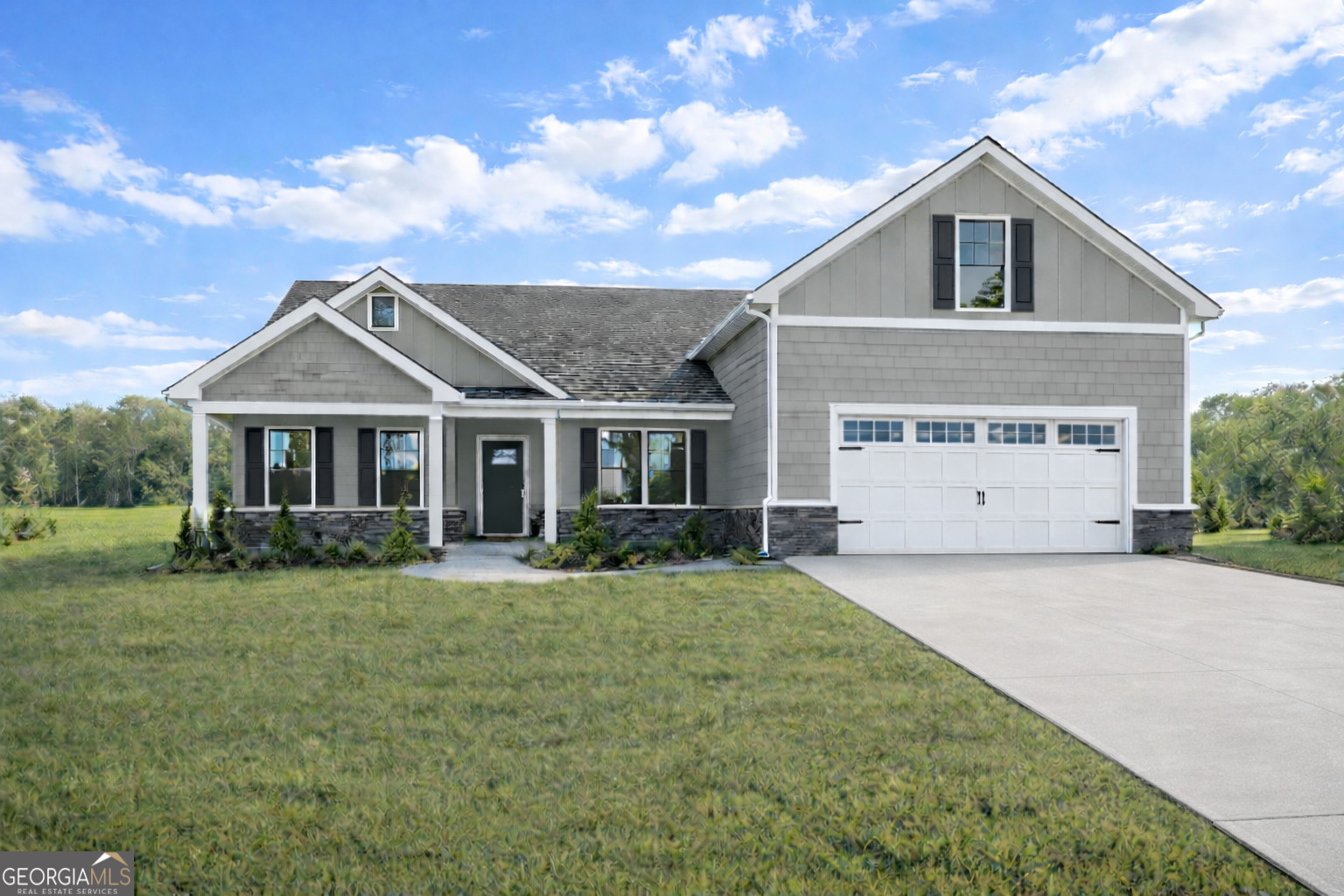 a front view of a house with a garden and yard