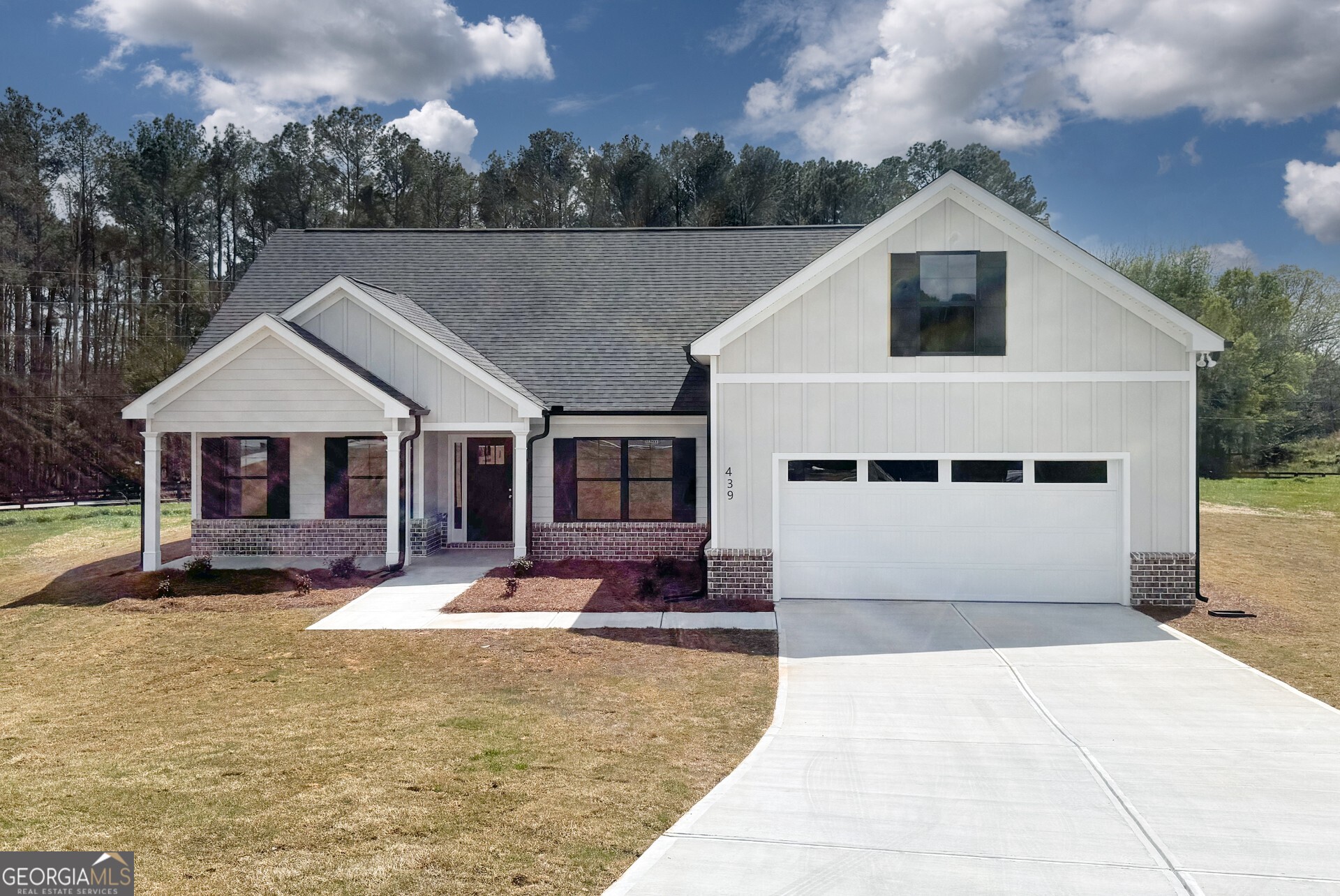439 Equestrian Walk Winder, GA 30680 - Photo 2 of 33 a front view of a house with a yard outdoor seating and covered with trees