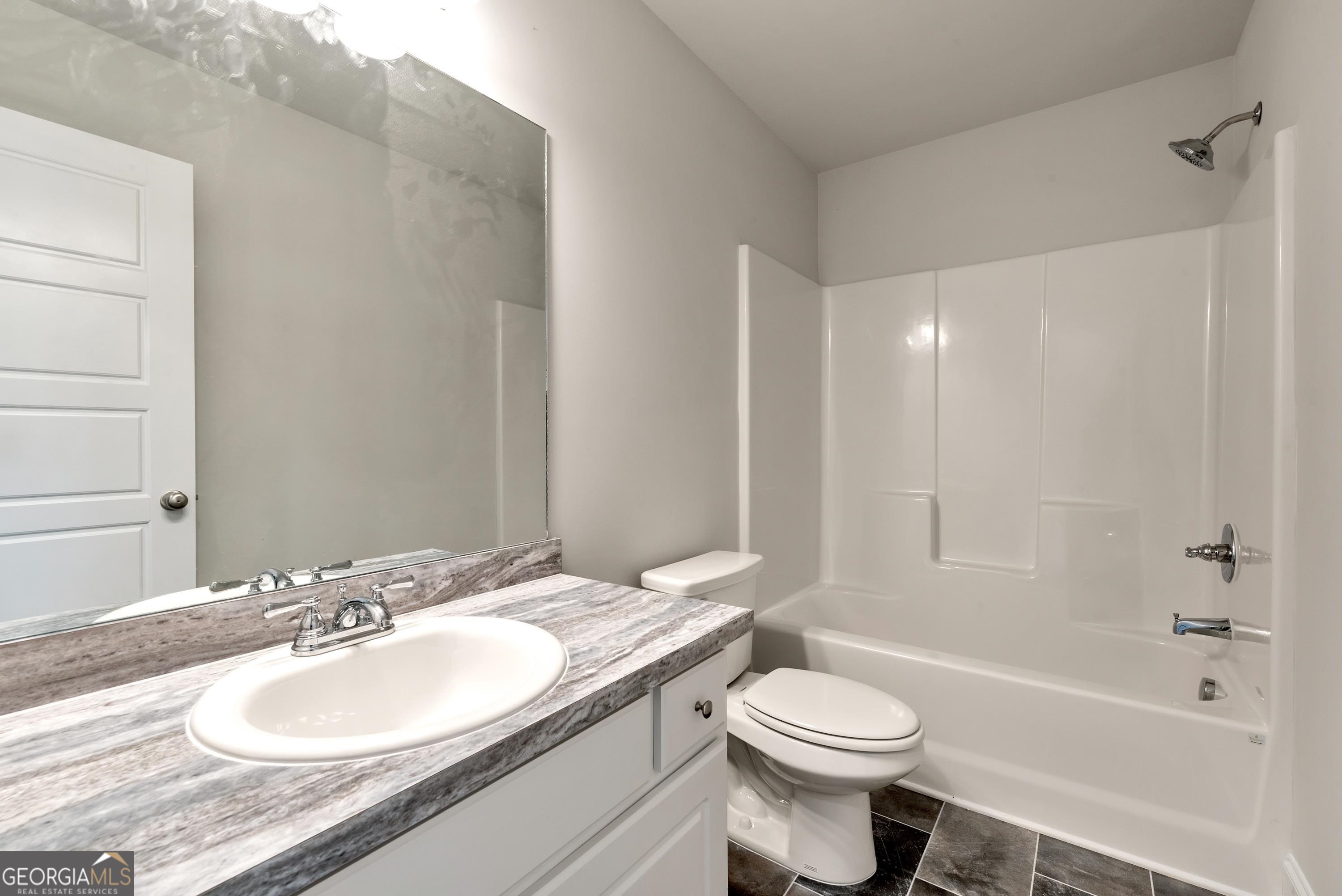 439 Equestrian Walk Winder, GA 30680 - Photo 23 of 33 a bathroom with a granite countertop sink toilet and shower