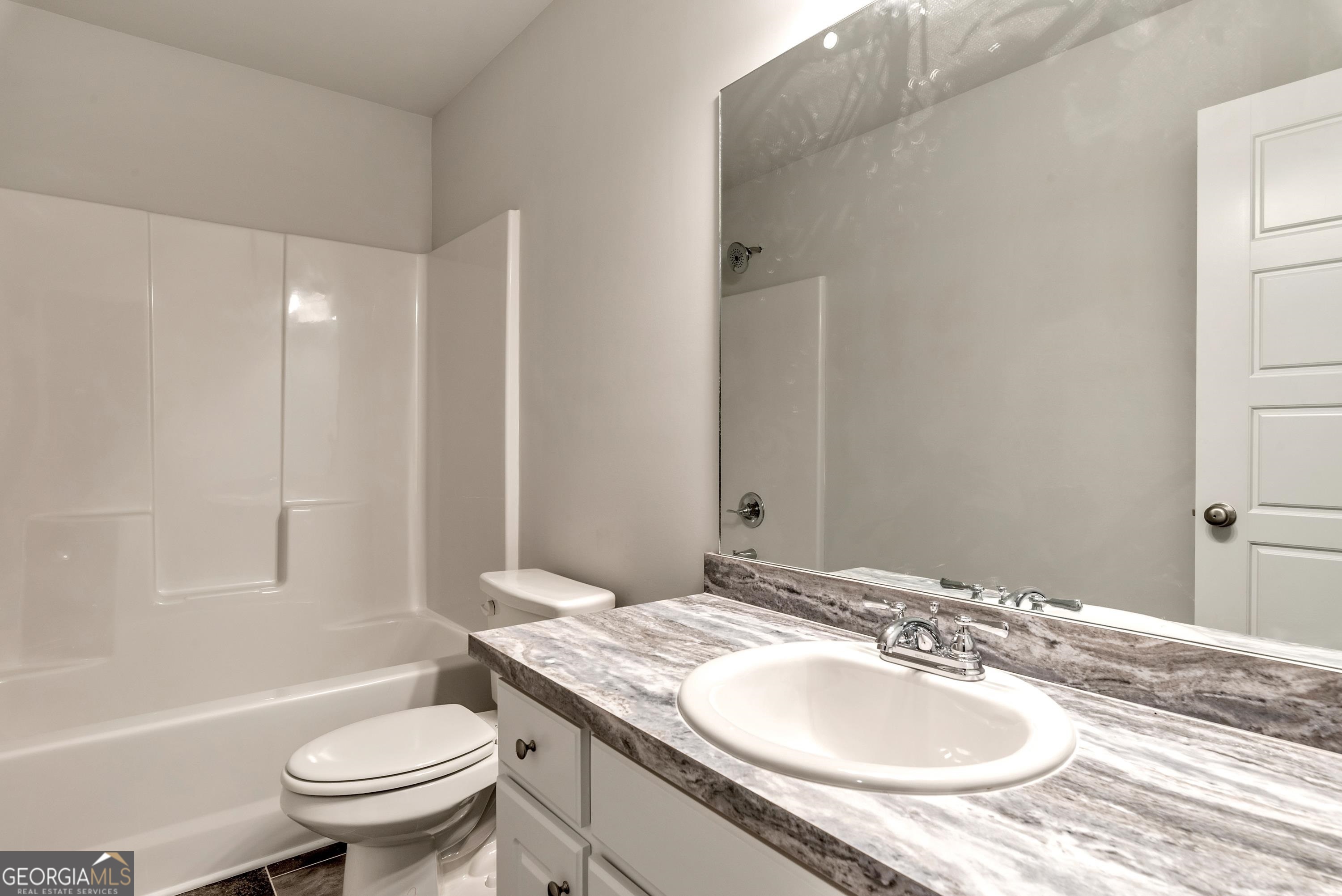 439 Equestrian Walk Winder, GA 30680 - Photo 26 of 33 a bathroom with a granite countertop sink toilet and shower