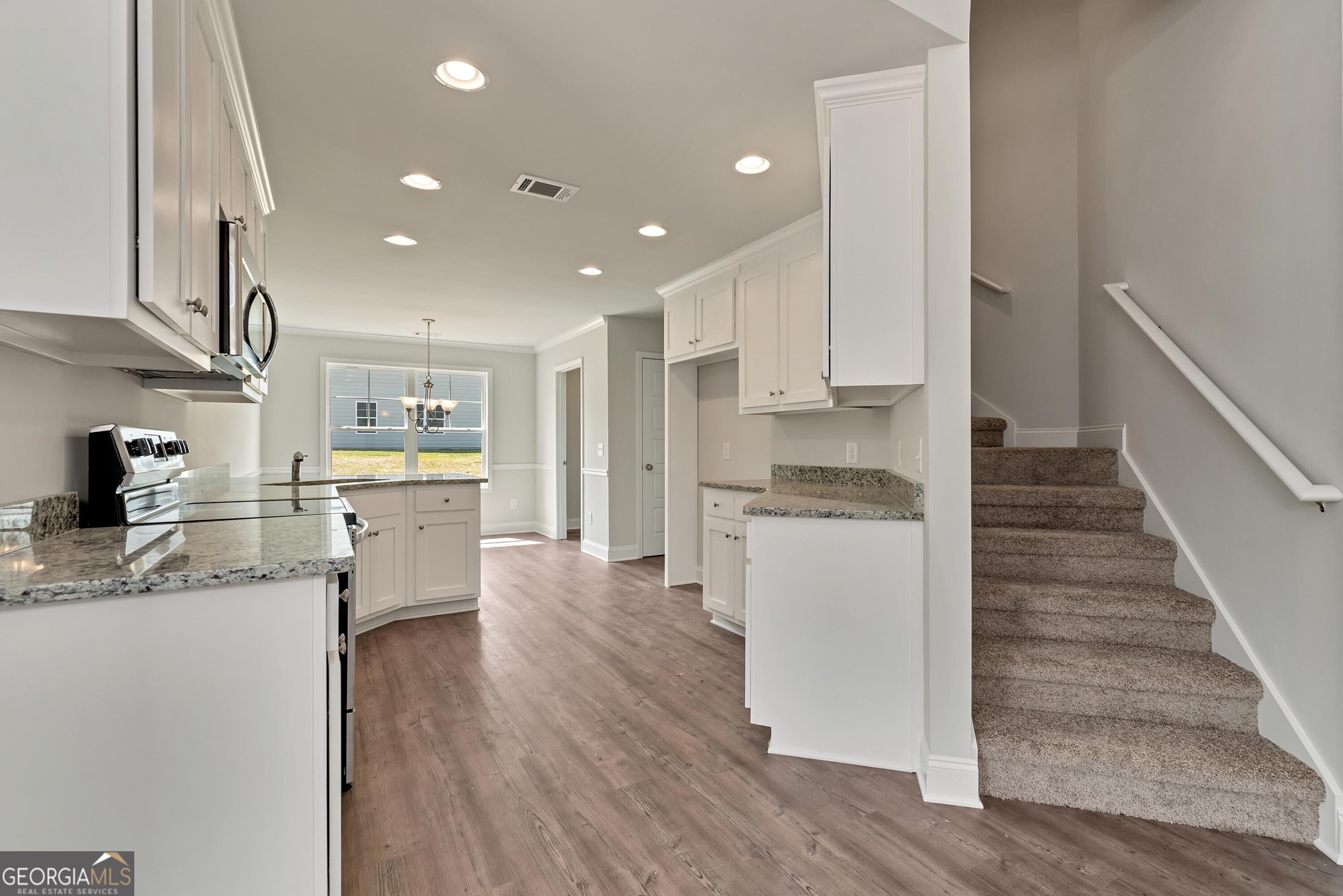 439 Equestrian Walk Winder, GA 30680 - Photo 6 of 33 a kitchen with a refrigerator and a stove top oven