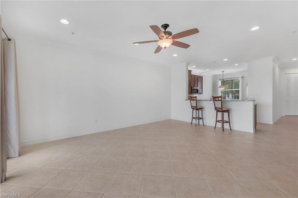 6505 Monterey Point, Unit 202 Naples, FL 34105 - Photo 3 of 30 The living room opens to the kitchen.