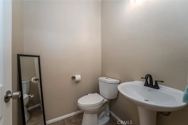 a white toilet sitting next to a white sink