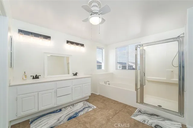 a spacious bathroom with a double vanity sink a mirror and a bathtub