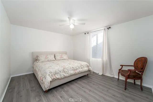 a bedroom with a bed a chair and a window