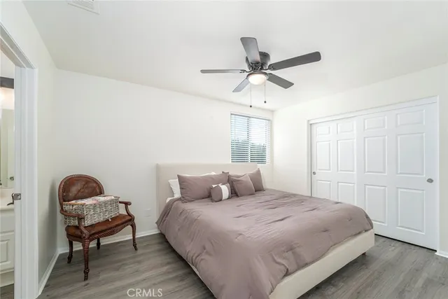 a bedroom with a bed a window and a chandelier