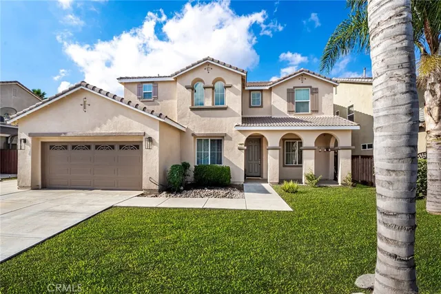 a front view of a house with a yard and garage
