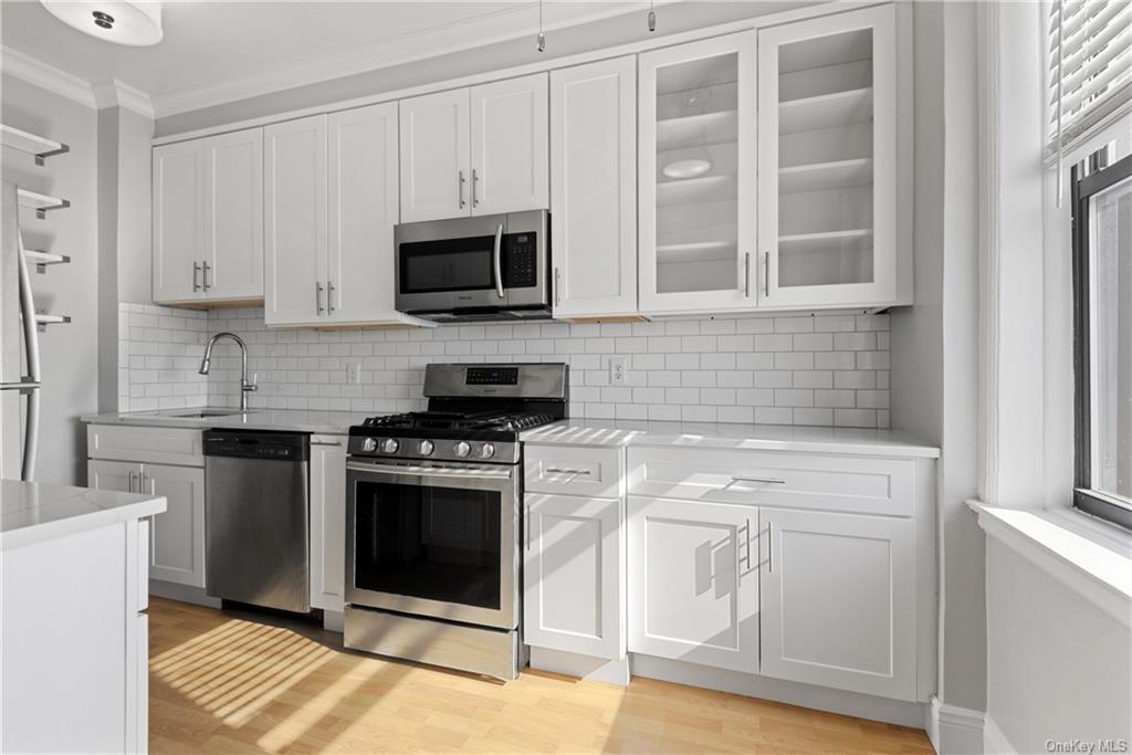 a kitchen with stainless steel appliances white cabinets and a stove