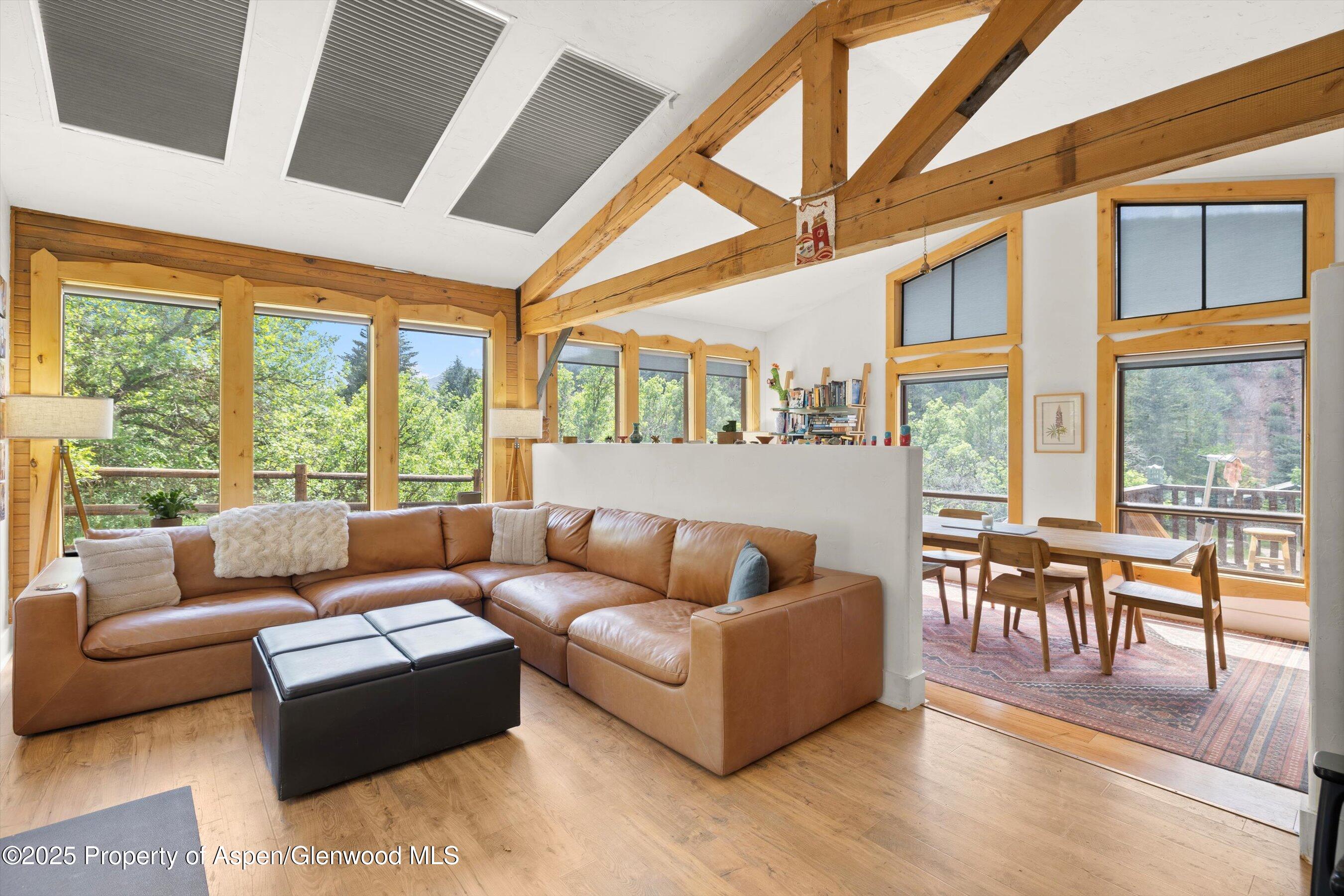 a living room with furniture and floor to ceiling windows