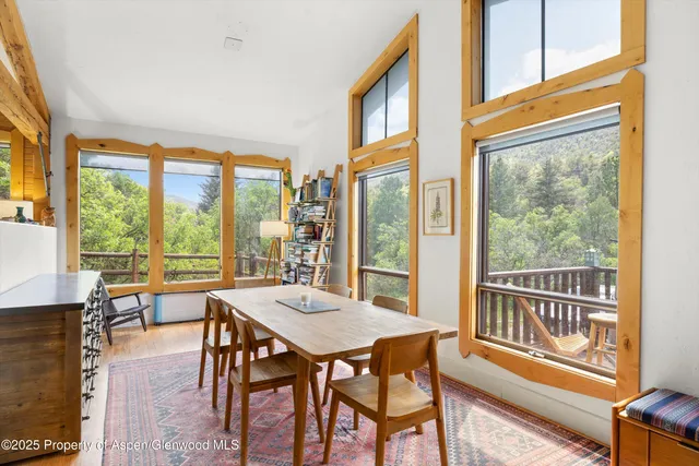 a dining room with furniture window and wooden floor