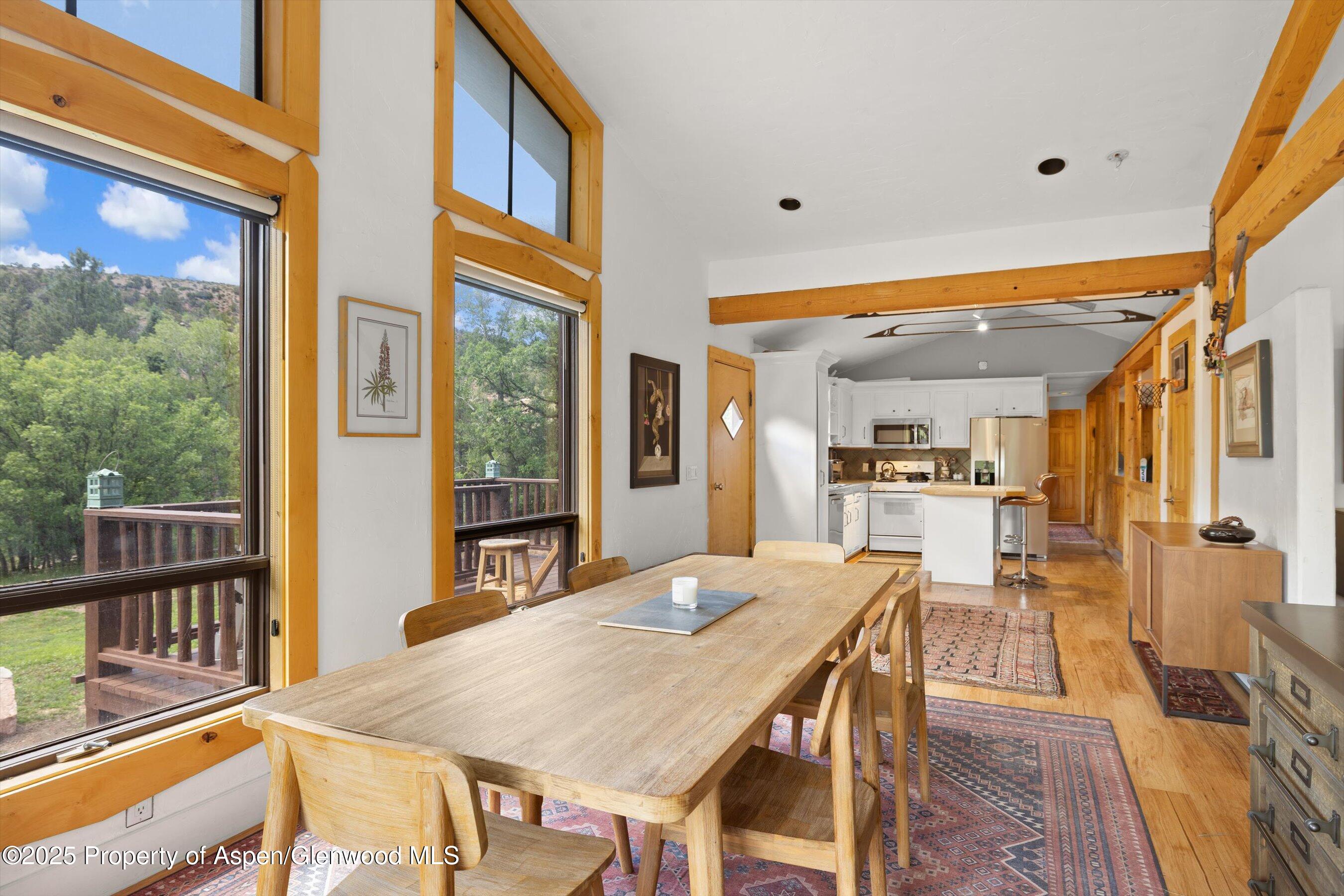 116 South Bill Creek Road Carbondale, CO 81623 - Photo 15 of 45 a dining room with furniture a window and wooden floor