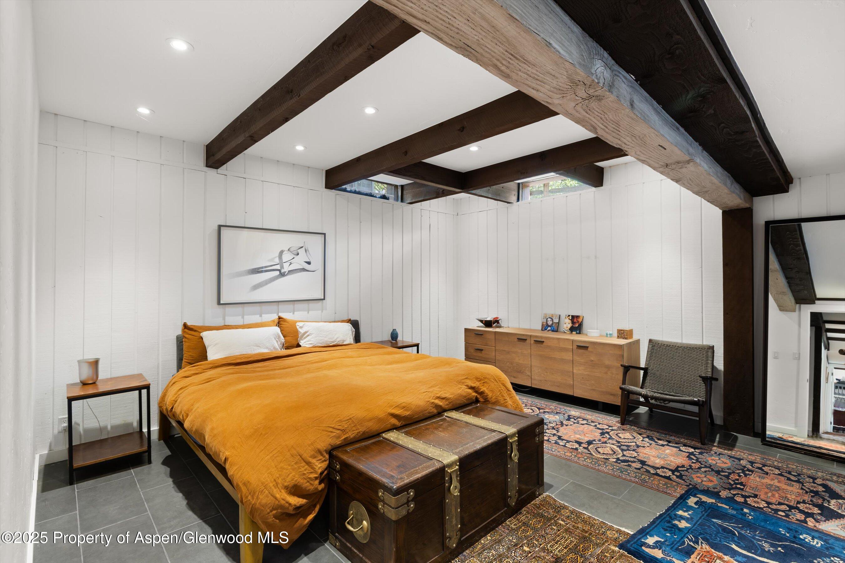 116 South Bill Creek Road Carbondale, CO 81623 - Photo 21 of 45 a bedroom with a bed and wooden floor