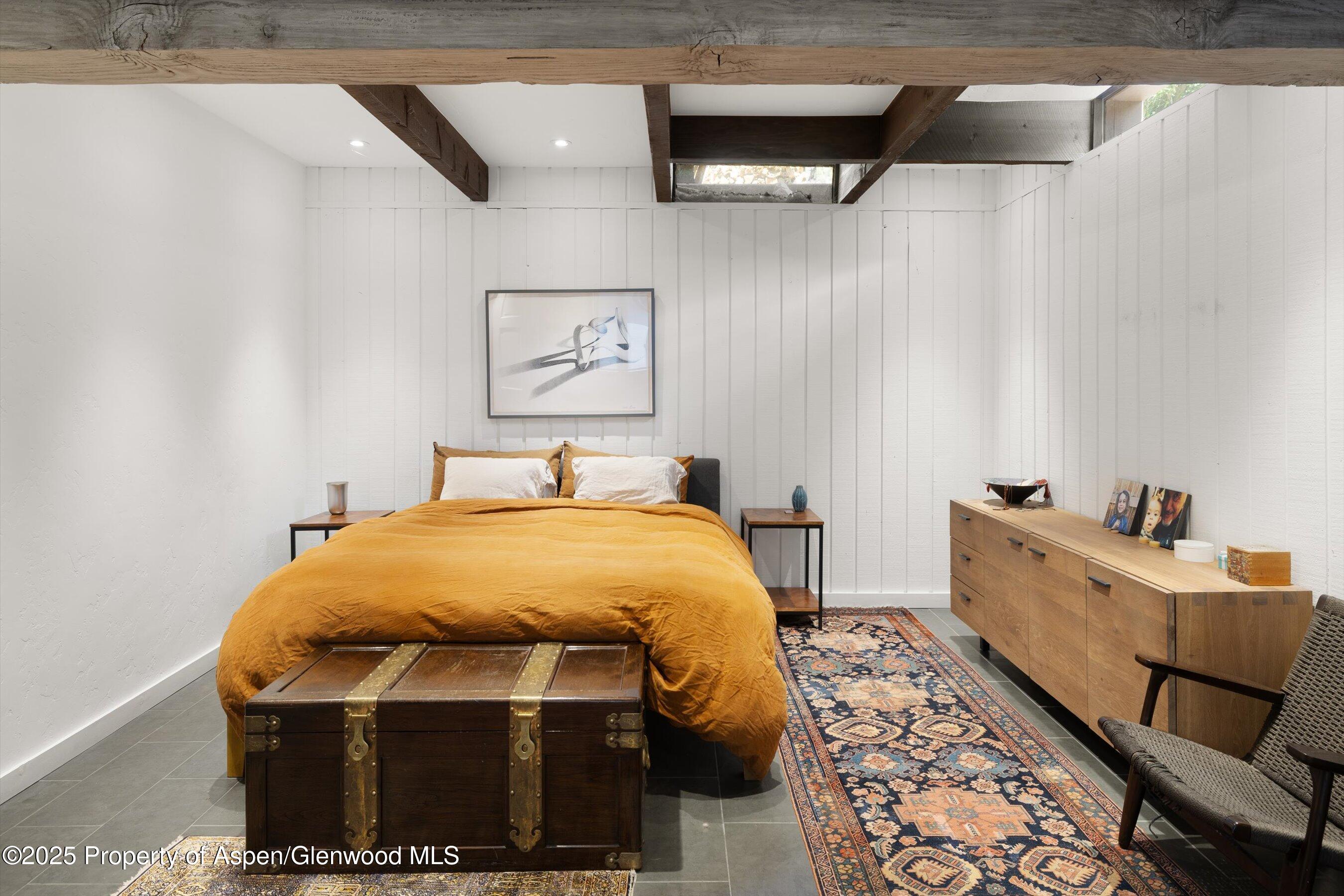 116 South Bill Creek Road Carbondale, CO 81623 - Photo 22 of 45 a bedroom with a bed and wooden floor