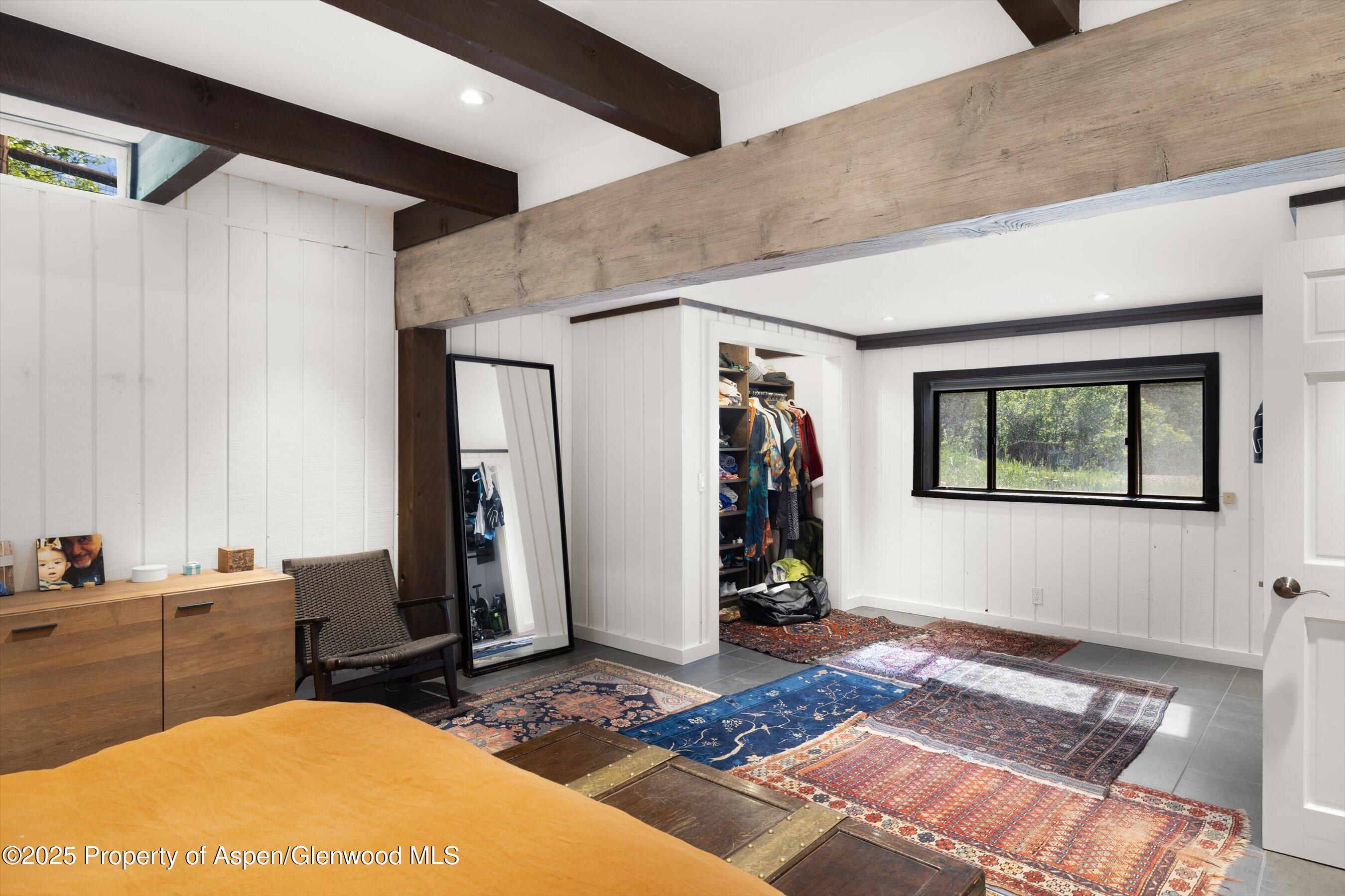 116 South Bill Creek Road Carbondale, CO 81623 - Photo 24 of 45 a bedroom with a bed and wooden floor
