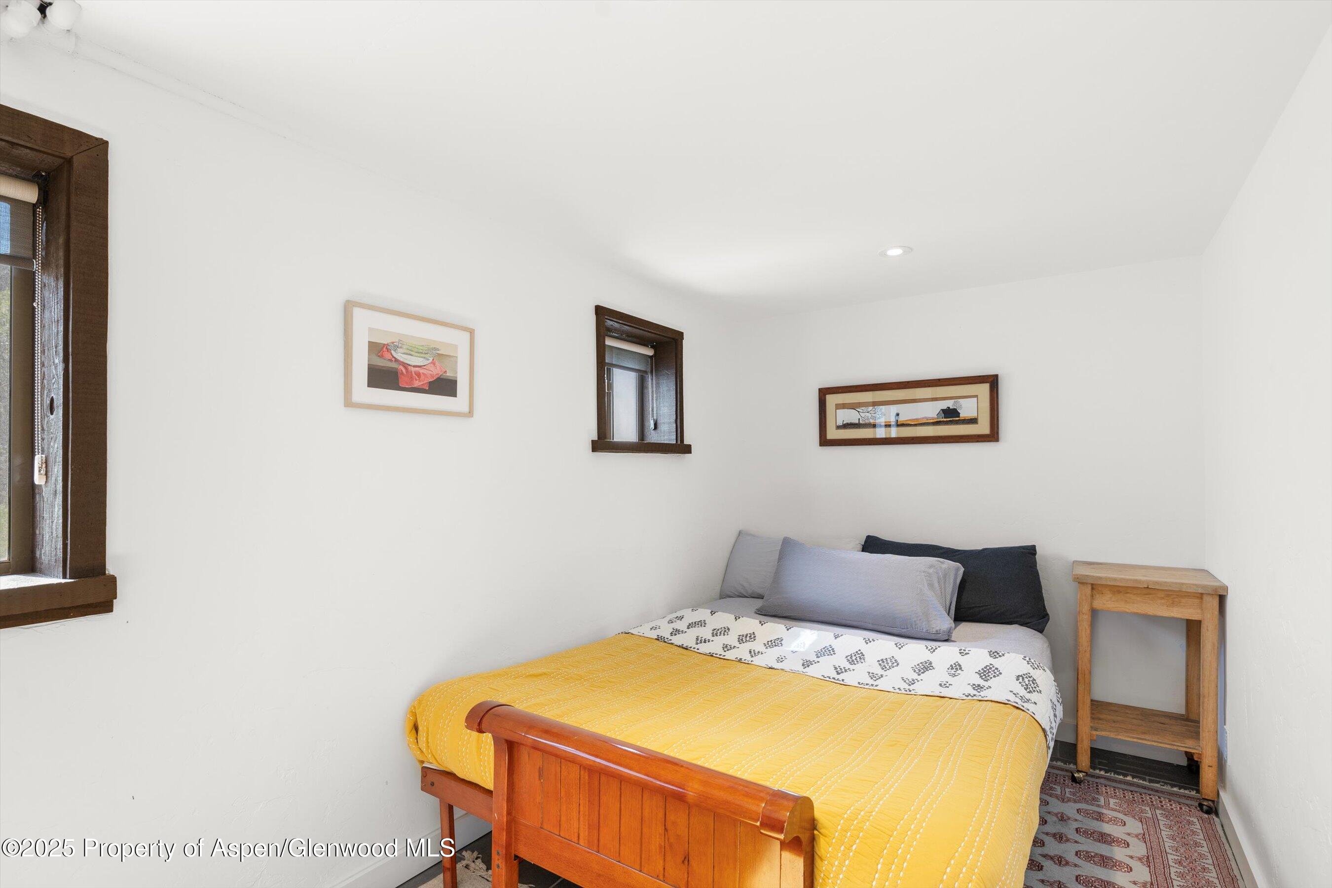 116 South Bill Creek Road Carbondale, CO 81623 - Photo 28 of 45 a bedroom with a bed and painting on the wall