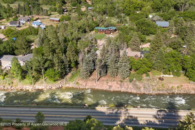 view of a mountain range with lush green forest
