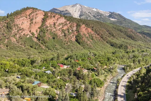 a view of a dry yard with mountains in the background