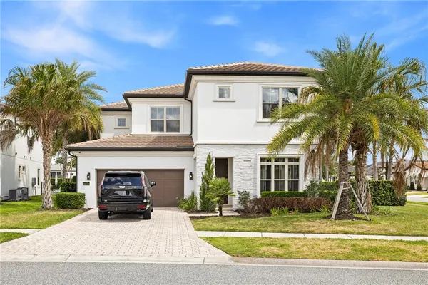 a view of a house with a patio and a yard