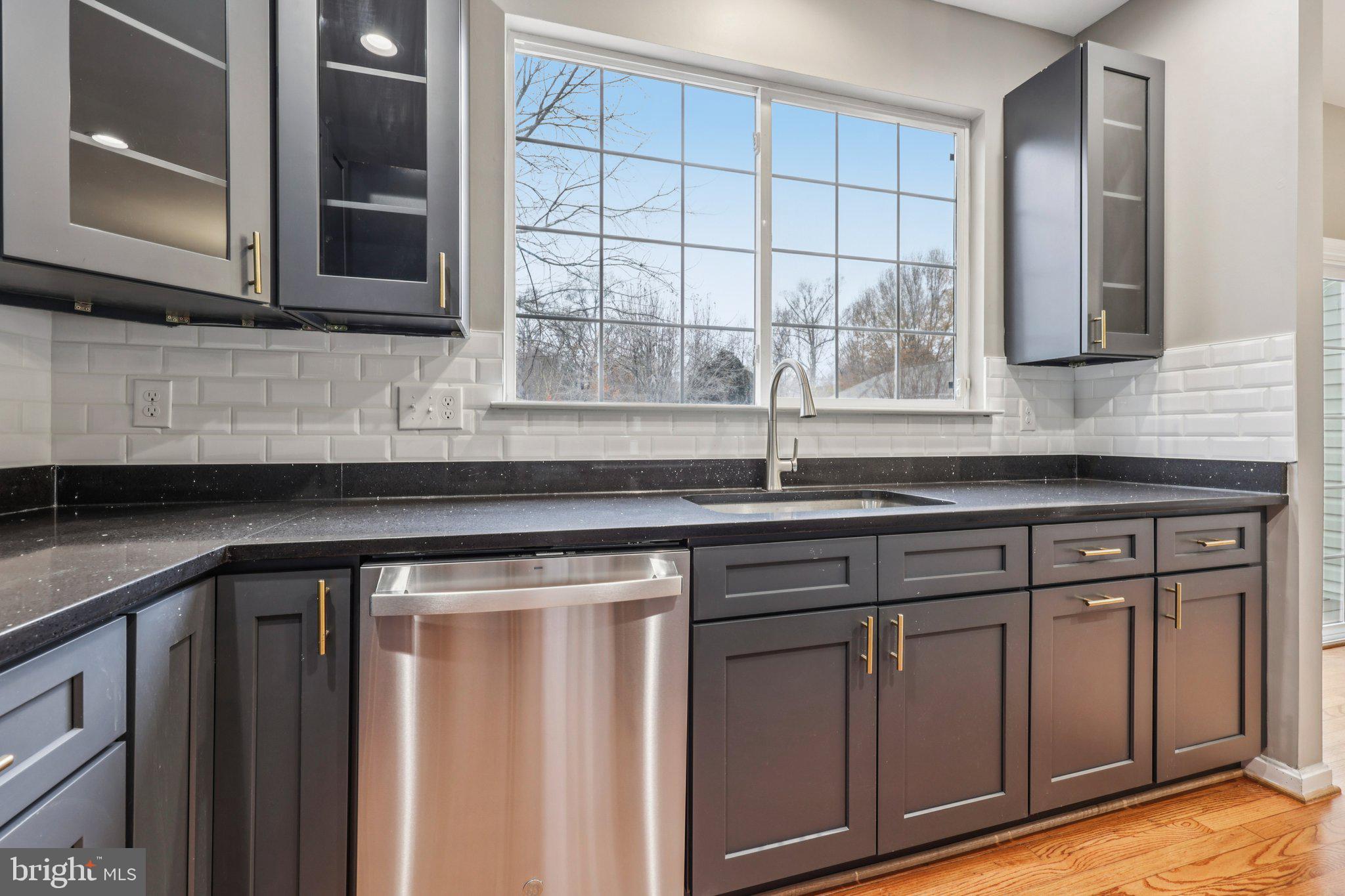 15730 Marbury Heights Way Montclair, VA 22025 - Photo 17 of 69 a kitchen with stainless steel appliances granite countertop a sink and a window