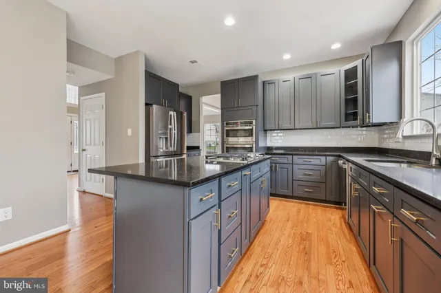 a view of an empty room with a wooden floor and a window