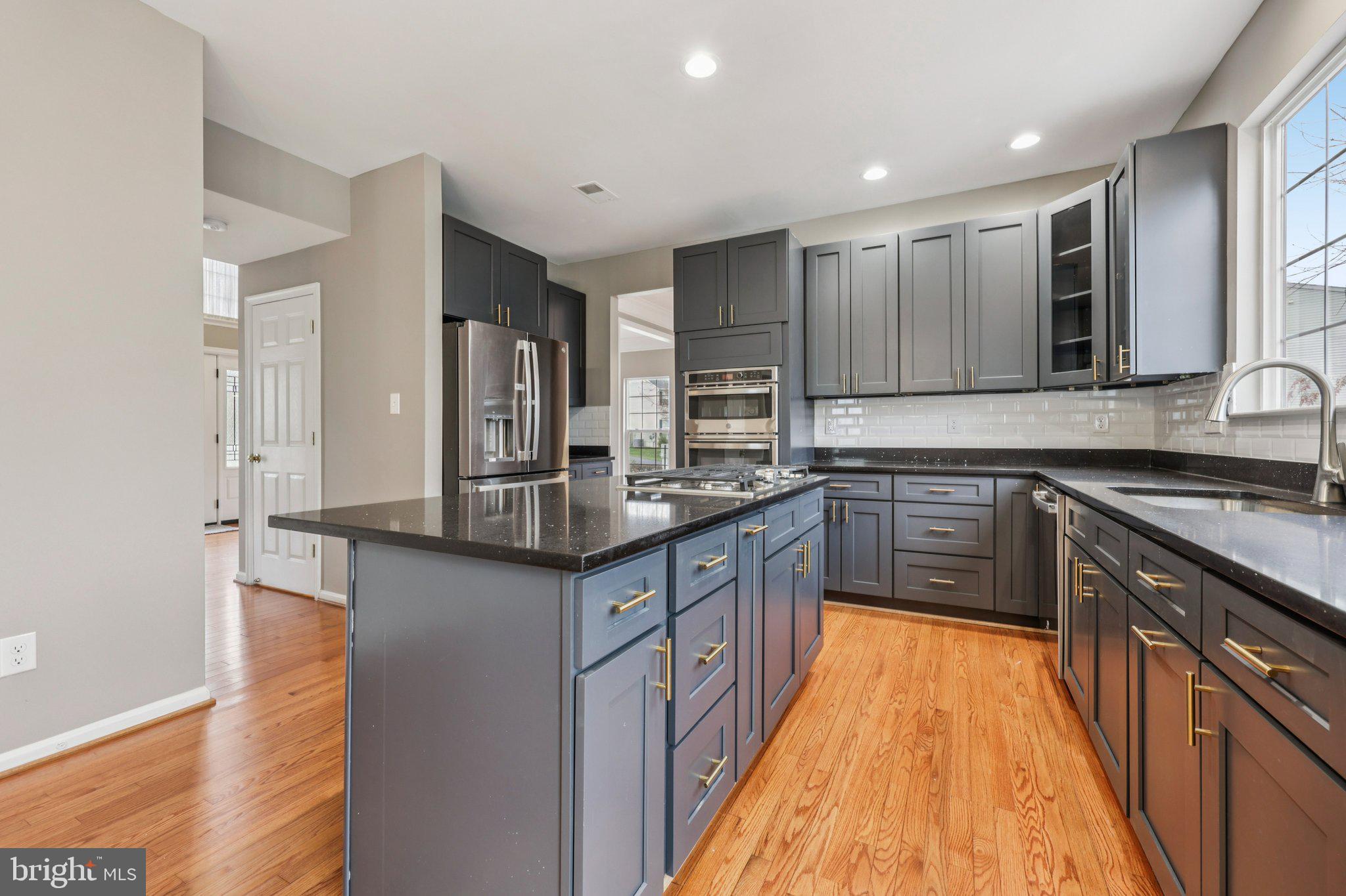 15730 Marbury Heights Way Montclair, VA 22025 - Photo 18 of 69 a kitchen with stainless steel appliances granite countertop a sink stove and refrigerator