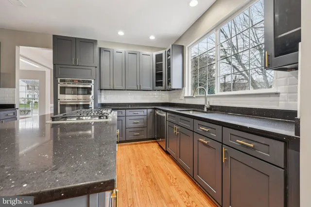 a view of empty room with wooden floor and windows