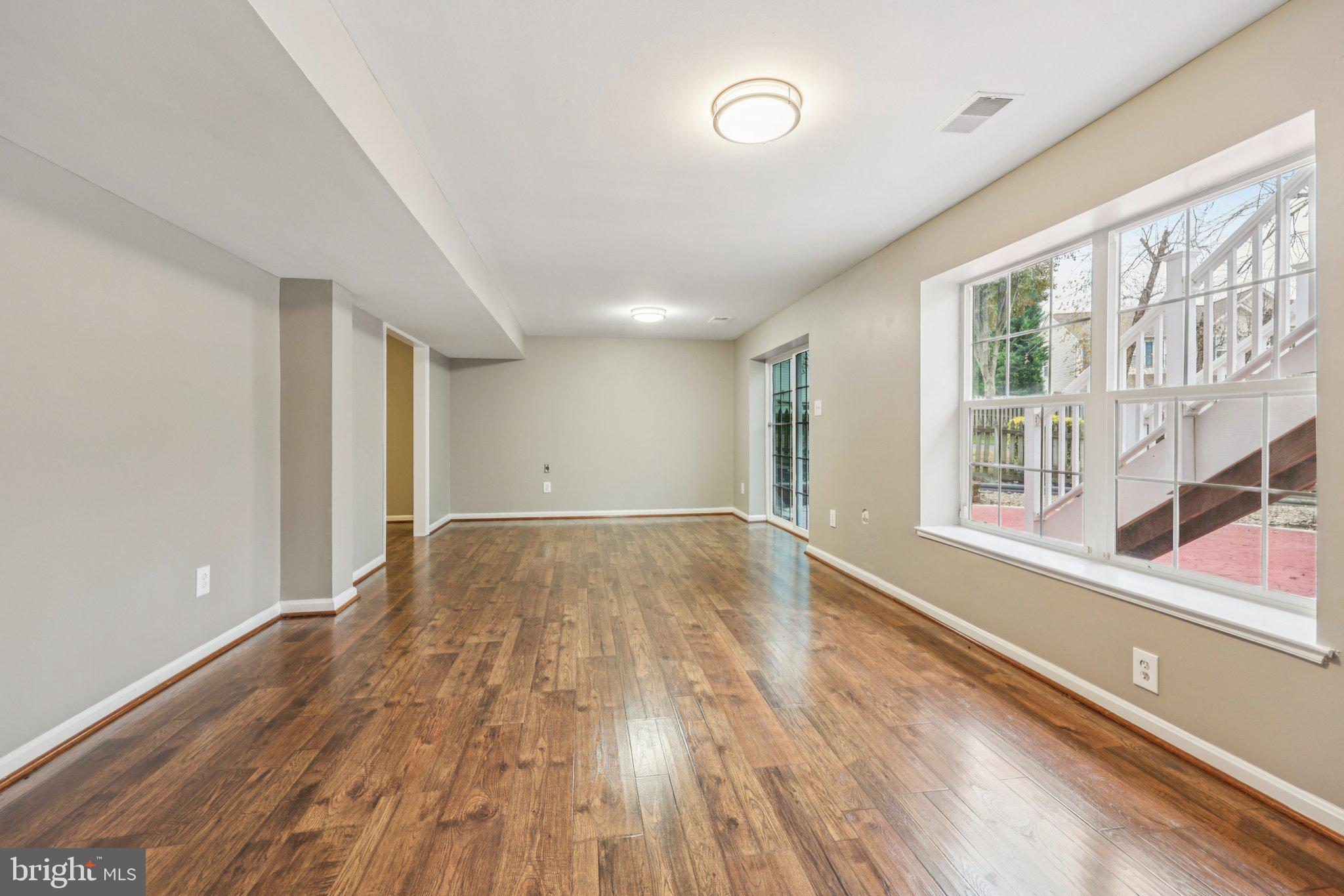 15730 Marbury Heights Way Montclair, VA 22025 - Photo 27 of 69 a view of an empty room with wooden floor and a window