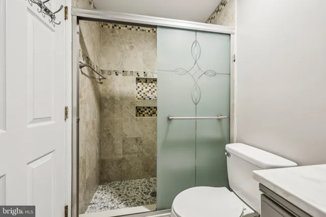 a view of a big room with wooden floor and windows