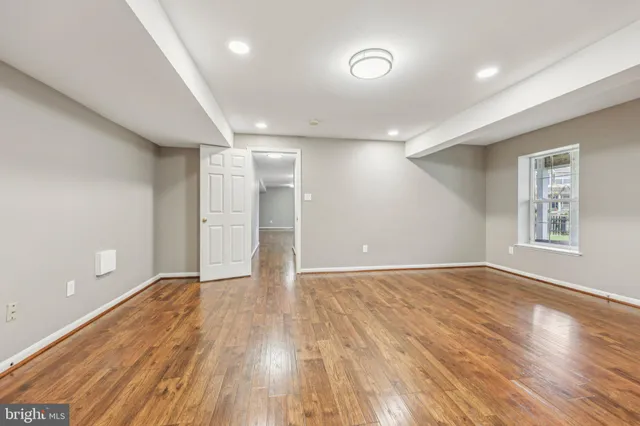 wooden floor in an empty room with a window