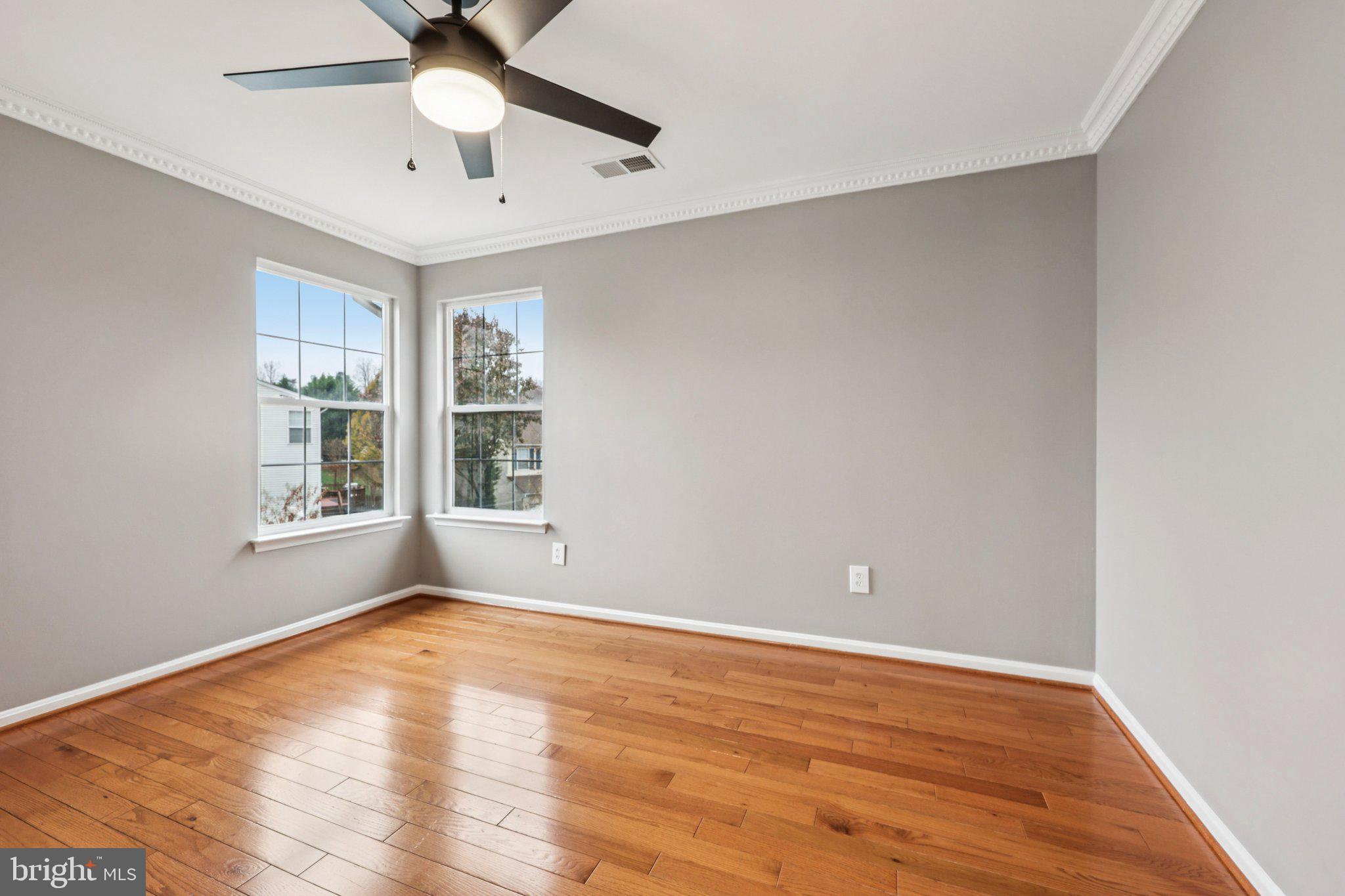 15730 Marbury Heights Way Montclair, VA 22025 - Photo 35 of 69 a view of an empty room with wooden floor and a window