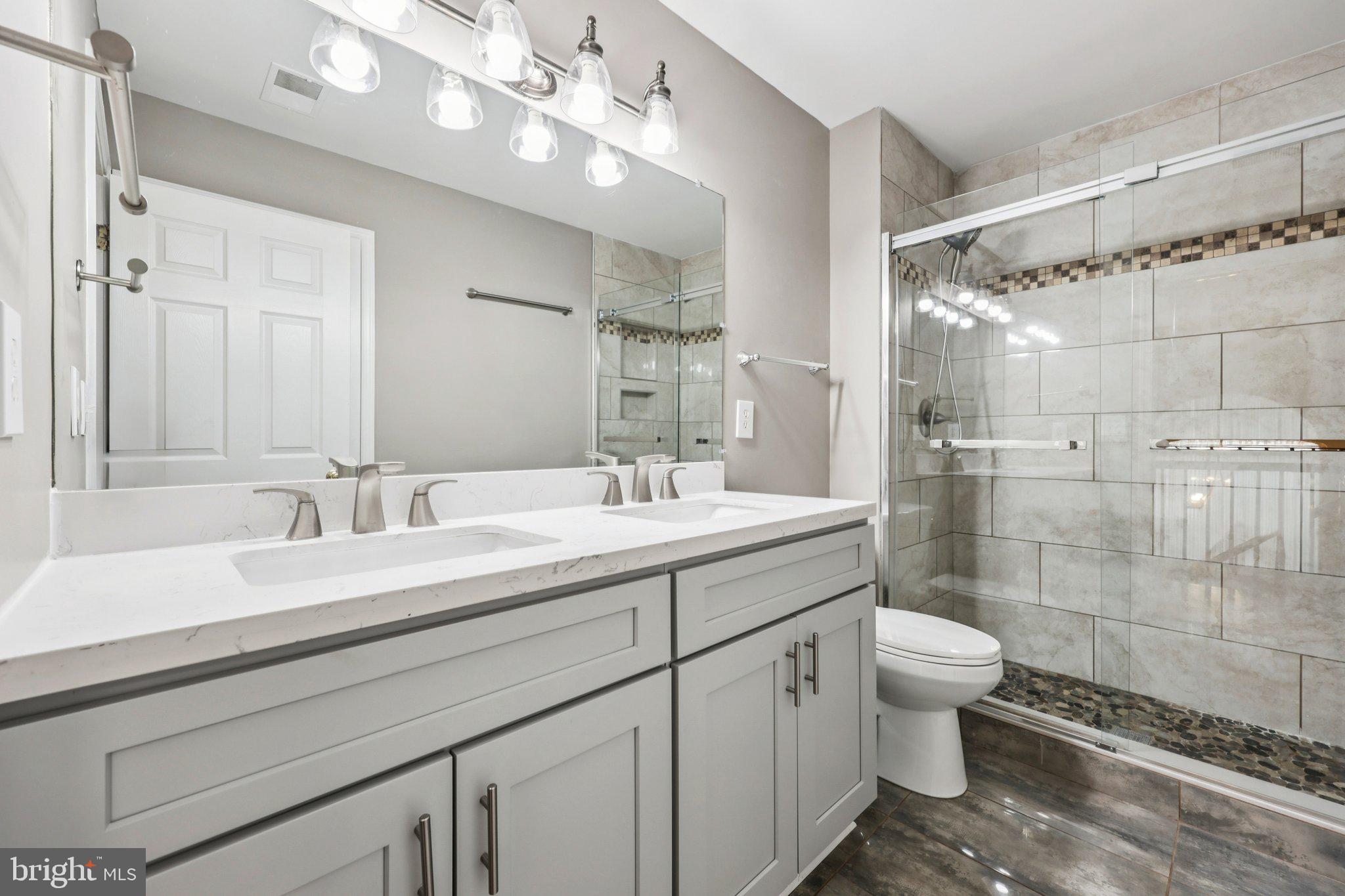 15730 Marbury Heights Way Montclair, VA 22025 - Photo 37 of 69 a bathroom with a double vanity sink mirror and toilet