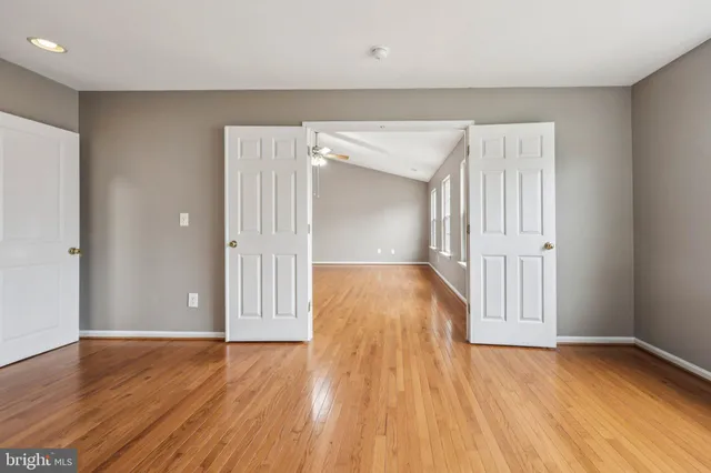 a view of a house with a big yard and large trees