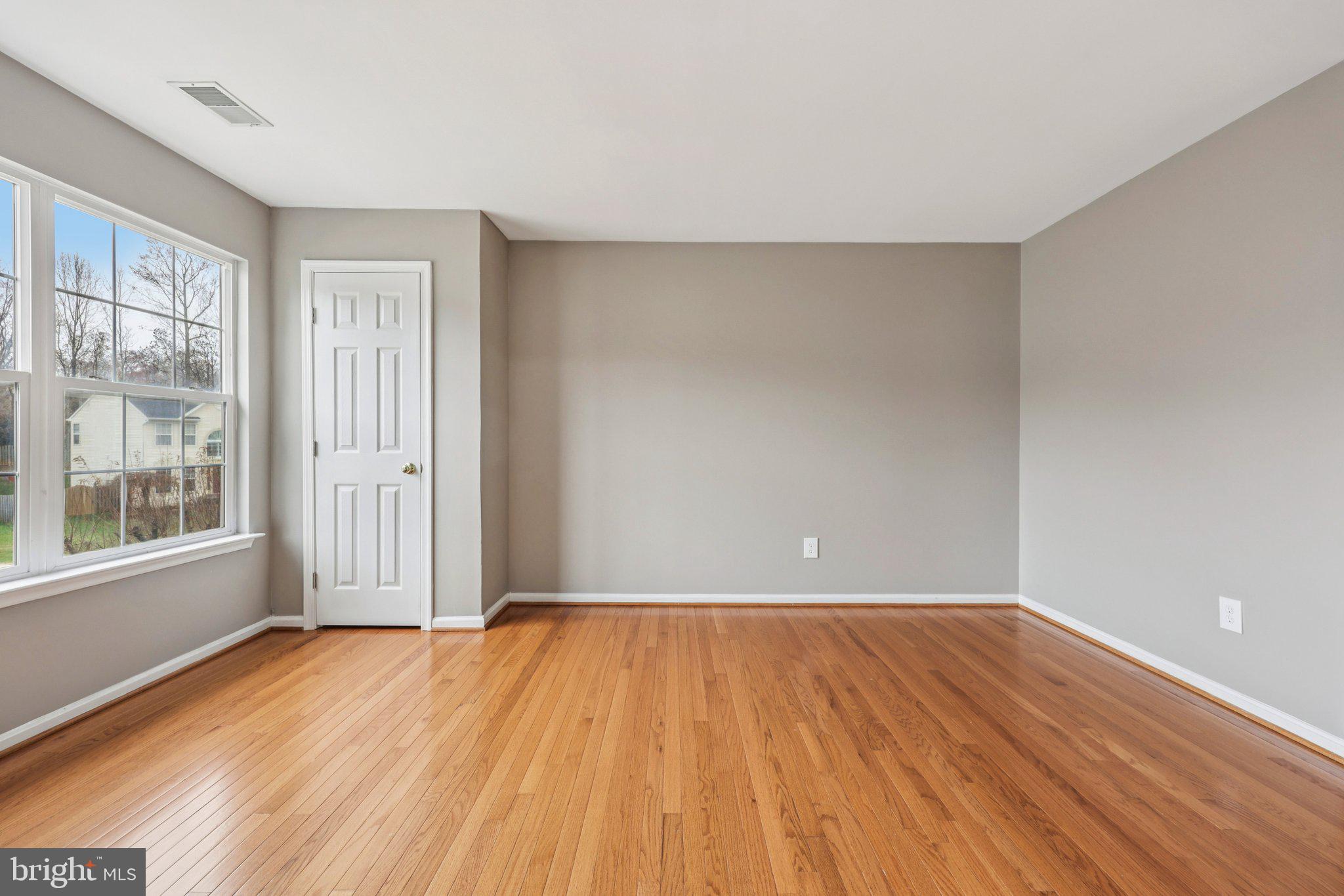 15730 Marbury Heights Way Montclair, VA 22025 - Photo 43 of 69 a view of an empty room with wooden floor and a window