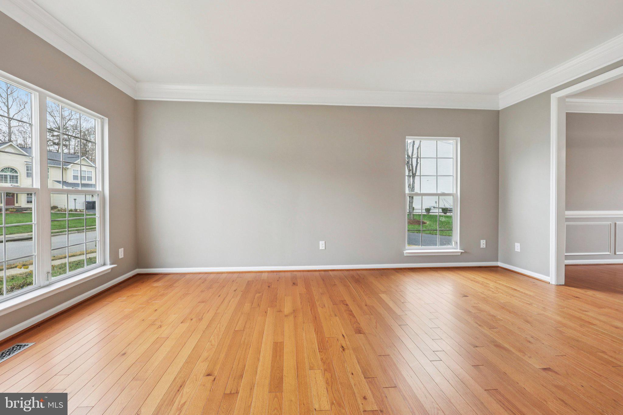 15730 Marbury Heights Way Montclair, VA 22025 - Photo 6 of 69 a view of an empty room with wooden floor and a window