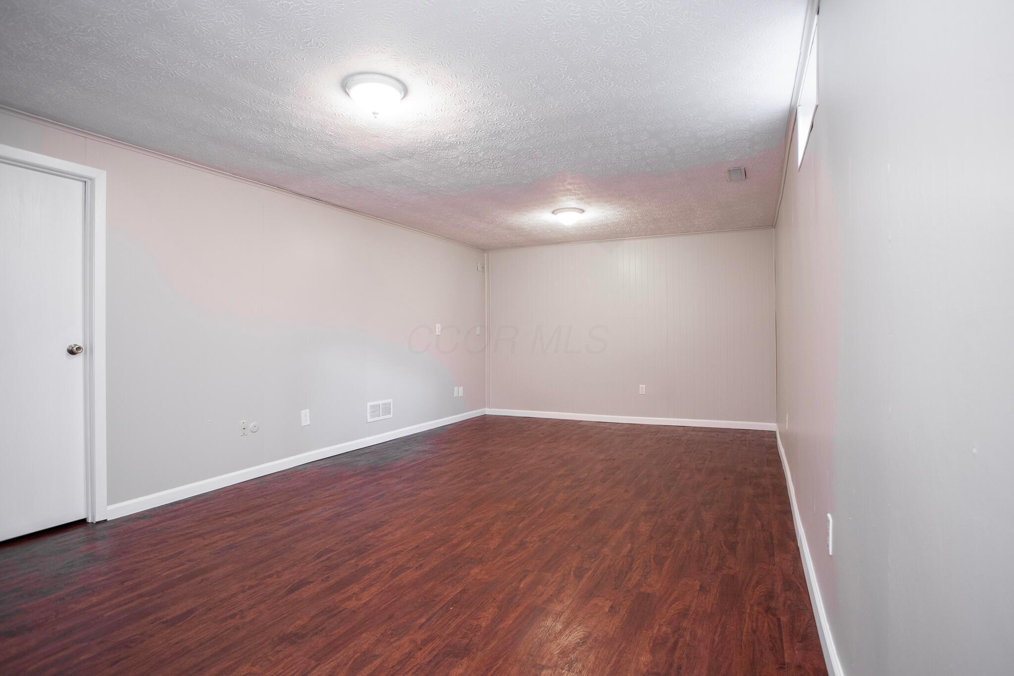 5222 Dierker Road, Unit D Columbus, OH 43220 - Photo 20 of 26 Finished Lower Level with vinyl plank floors