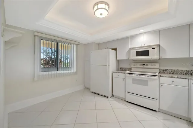 a kitchen with granite countertop a sink and cabinets