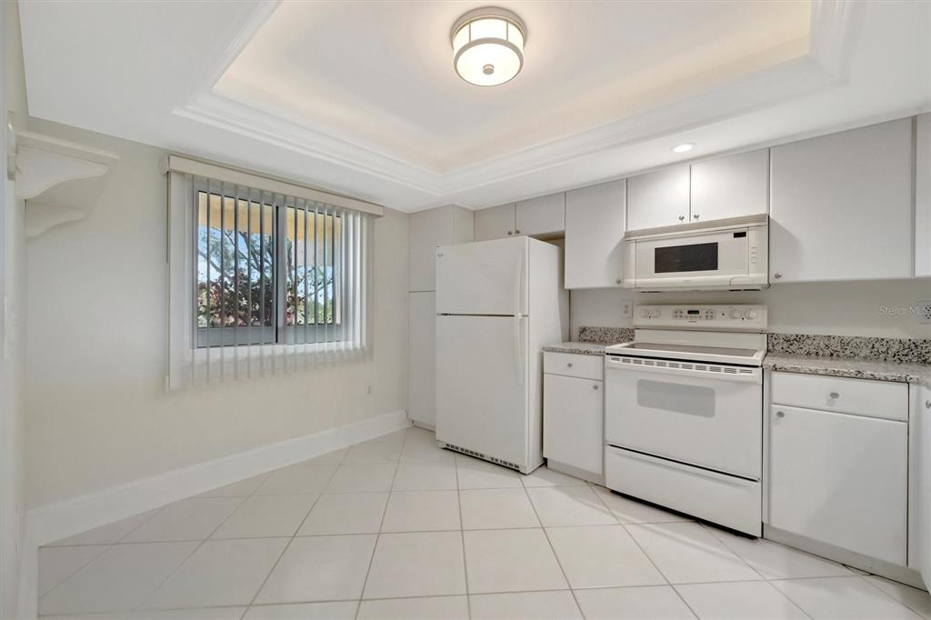 9604 Cortez Road West, Unit 222 Bradenton, FL 34210 - Photo 14 of 54 a kitchen with cabinets appliances and a window