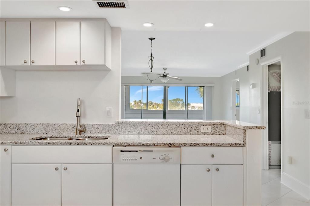 9604 Cortez Road West, Unit 222 Bradenton, FL 34210 - Photo 17 of 54 a kitchen with granite countertop a sink and cabinets