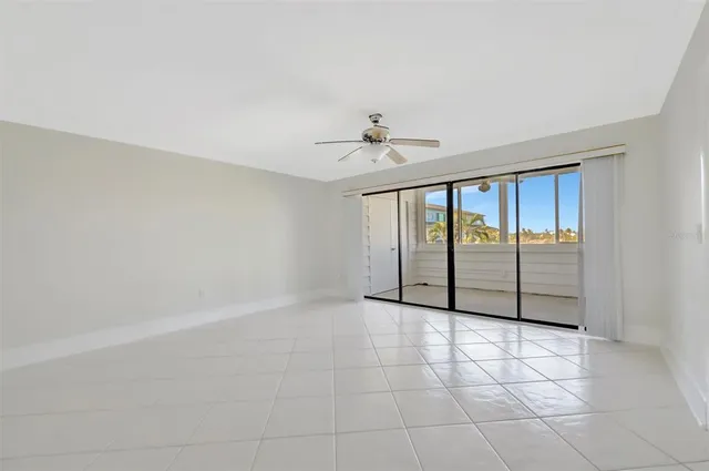 a view of room with window and ceiling fan