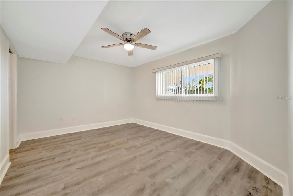 9604 Cortez Road West, Unit 222 Bradenton, FL 34210 - Photo 31 of 54 a view of an empty room with wooden floor and a window