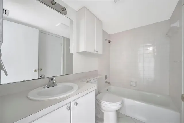 a view of empty room with wooden floor and ceiling fan