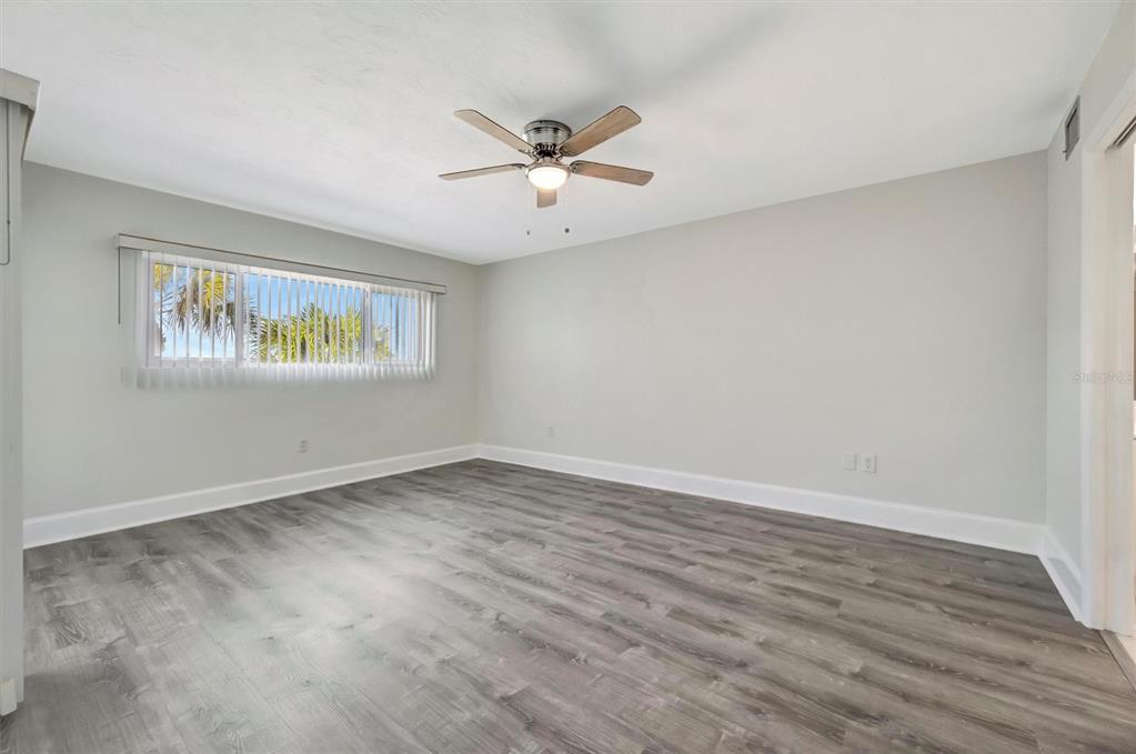 9604 Cortez Road West, Unit 222 Bradenton, FL 34210 - Photo 38 of 54 a view of an empty room with wooden floor and a window