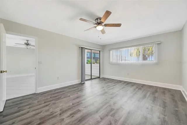 a living room with furniture a bookshelf and a window