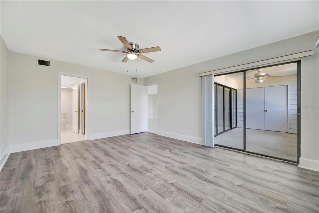 9604 Cortez Road West, Unit 222 Bradenton, FL 34210 - Photo 41 of 54 a view of empty room with wooden floor and ceiling fan