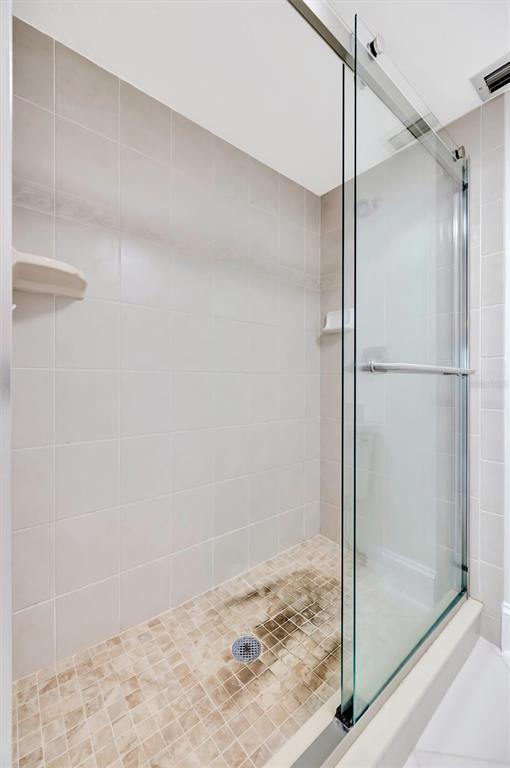 9604 Cortez Road West, Unit 222 Bradenton, FL 34210 - Photo 43 of 54 a bathroom with a glass shower door