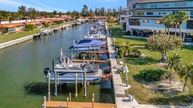 a kitchen with granite countertop a stove a sink and a refrigerator