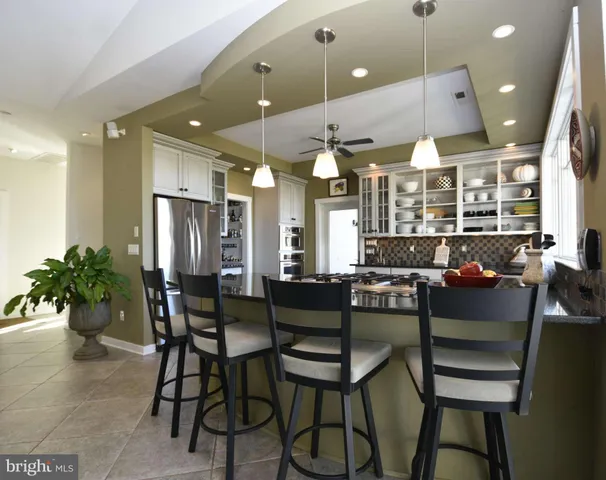 a living room with furniture a potted plant and a lamp