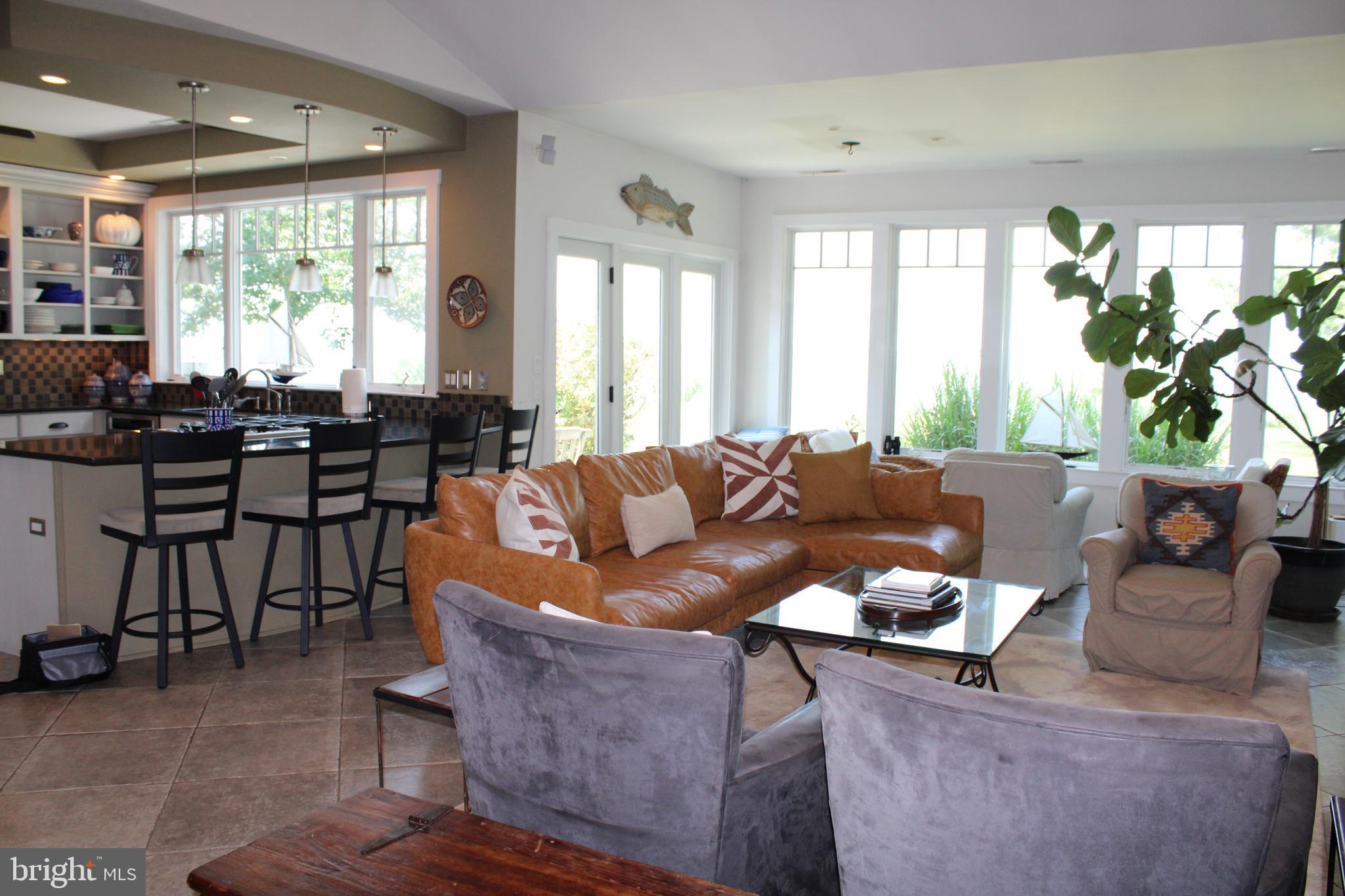 6050 Sunset Lane Tilghman, MD 21671 - Photo 22 of 74 a living room with furniture and a large window