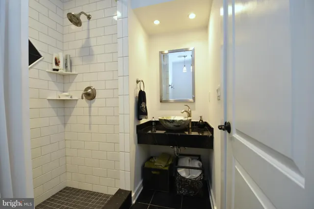 a bathroom with a sink mirror and toilet
