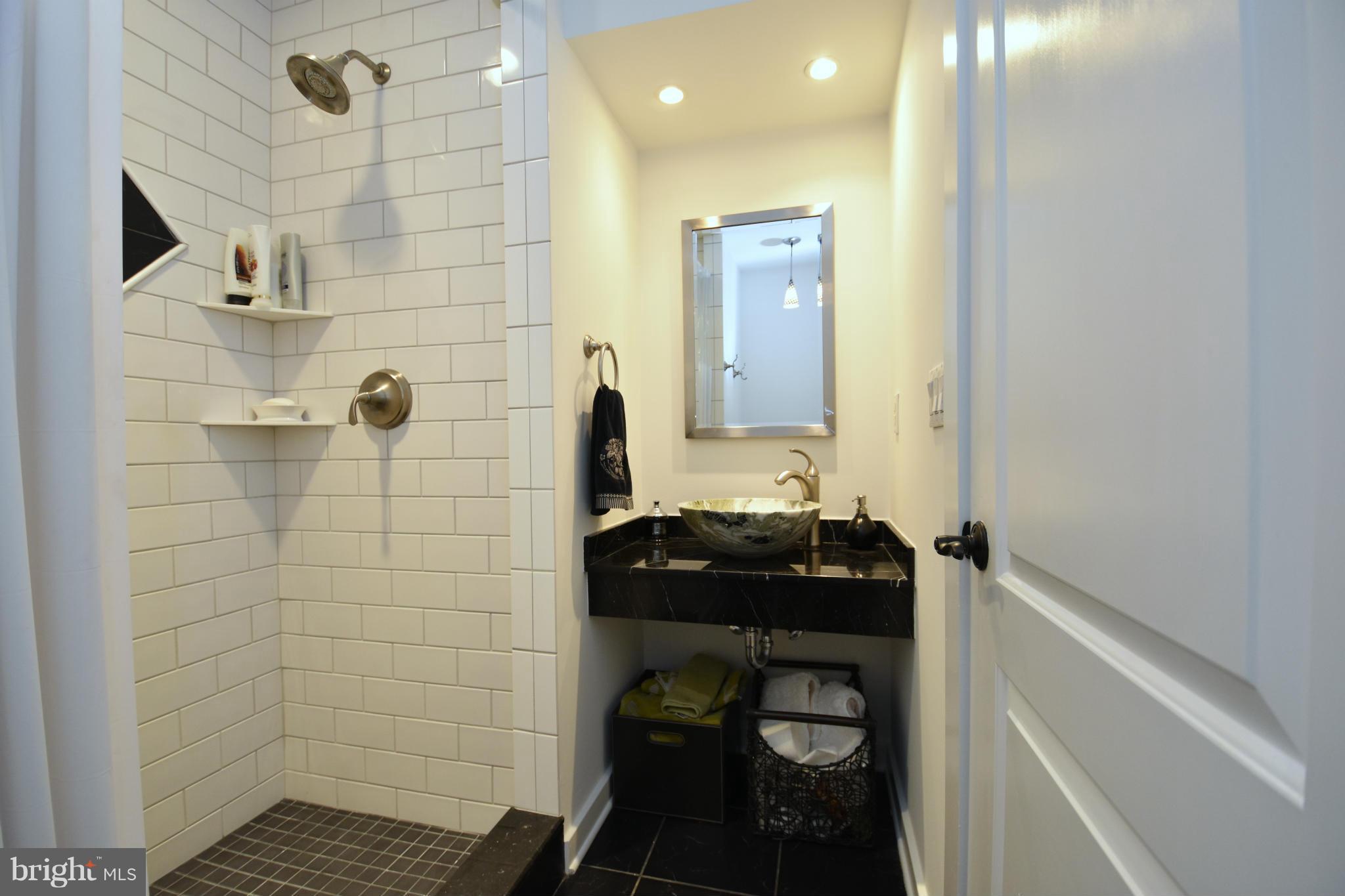 6050 Sunset Lane Tilghman, MD 21671 - Photo 30 of 74 a bathroom with a sink and a mirror